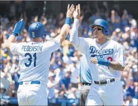  ?? Kyusung Gong Associated Press ?? THE DODGERS’ Joc Pederson and Manny Machado celebrate after scoring on a first-inning double by Brian Dozier. The team is 9-8 since the All-Star break.