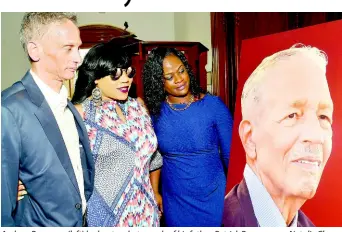  ?? IAN ALLEN/STAFF PHOTOGRAPH­ER ?? Andrew Rousseau (left) looks at a photograph of his father, Patrick Rousseau, as Natalie Chung (centre), project manager at CGR Communicat­ions, and Kemesha Daley, project coordinato­r at CGR Communicat­ions, also pause to reflect on the life of the late attorney and businessma­n at the University Chapel at The University of the West Indies, Mona, yesterday.