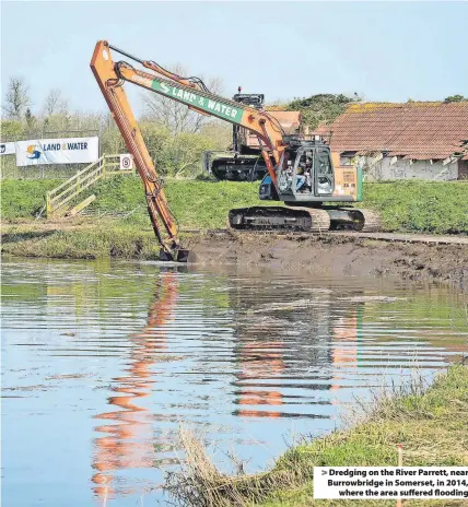  ?? ?? Dredging on the River Parrett, near Burrowbrid­ge in Somerset, in 2014, where the area suffered flooding
