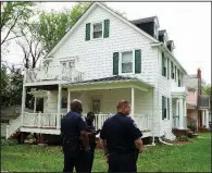  ?? AP/JOSE LUIS MAGANA ?? Baltimore police officers stand Thursday outside the home of Mayor Catherine Pugh, hours after it was raided by federal agents.