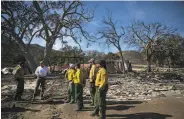  ?? Jae C. Hong / Associated Press ?? Interior Secretary Ryan Zinke (second left) talks to firefighte­rs in Agoura Hills, Los Angeles County.