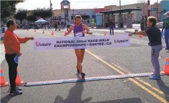  ?? GLAE THIEN ?? Former El Cajon resident Nick Christie crosses the finish line in winning the men’s 35K race walk in Santee.