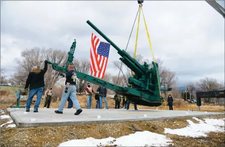  ?? MORGAN TIMMS/Taos News ?? Taos VFW Post 3259 members help Manuel Medina, of Robert Medina & Sons Concrete & Sand, move a World War II artillery piece Saturday (Jan. 23) to Not Forgotten Outreach’s Veteran’s Living Memorial Park.