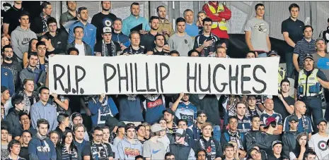  ?? Picture: GETTY IMAGES ?? COLLECTIVE TRIBUTE: Melbourne Victory supporters pause for a moment’s silence as they pay their respects to deceased Australian cricketer Phillip Hughes during the round eight A-League match between Melbourne Victory and Adelaide United at AAMI Park...
