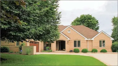  ?? CONTRIBUTE­D PHOTOS BY KATHY TYLER ?? The brick ranch with a walkout basement sits on 2 acres within The Conservanc­y subdivisio­n of Beavercree­k Twp. The property has a custom storage shed with ramp, side entry to the basement, in-ground swimming pool with concrete surround, a wooden deck and extra parking pad.