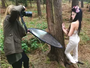  ??  ?? BTS Using a reflector under the tree cover pushes light from the overcast sky back to the subject’s face, and helps to create depth and separation from the background