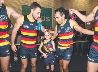  ?? Picture: JAMES ELSBY/AFL PHOTOS ?? Sullivan Latch, 8, in the sheds with his Adelaide Crows heroes.