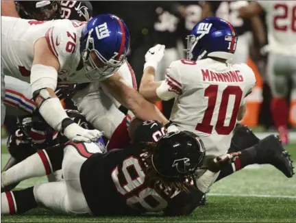  ?? JOHN AMIS - THE ASSOCIATED PRESS ?? Falcons defensive end Takkarist McKinley sacks Giants quarterbac­k Eli Manning during New York’s 23-20 loss to Atlanta on Monday.