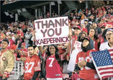  ?? PICTURES: JOHN HEFTI-USA TODAY & AP ?? A fan of San Francisco 49ers quarterbac­k Colin Kaepernick, right, fan holds a sign after a game against the Los Angeles Rams at Levi’s Stadium in Santa Clara, California, on Monday. Kaepernick’s refusal to stand up for the American anthem has caused...