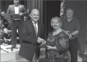  ?? The Sentinel-Record/Richard Rasmussen ?? VETERAN RECOGNIZED: Lakeside Superinten­dent Shawn Cook, left, presents an honorary diploma to Vivian Gray Erichsen, who served as a dental assistant in the U.S. Navy during the Vietnam War, during a Veterans Day program at Lakeside Middle School Monday.