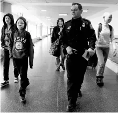  ??  ?? Supervisor­y officer Huss (second right) for US Customs and Border Protection escorts; Emmanuel Rutema,Mwigulu Magesa,Elissa Montanti,founder of the Global Medical Relief Fund and Pendo Noni,(left to right) following their arrival at JFK Internatio­nal...