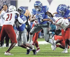  ?? MARK WEBER, THE COMMERCIAL APPEAL ?? Memphis running back Patrick Taylor Jr., (middle) scrambles past the South Alabama defense during action in Memphis, Tenn., Saturday, September 22, 2018.