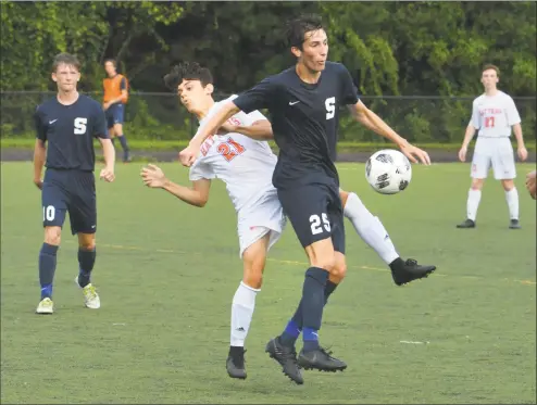  ?? Alex von Kleydorff / Hearst Connecticu­t Media ?? Staples’ Austin Sholes gets the ball away from Danbury’s Lucas Oliveira during Wednesday’s game in Westport.