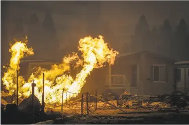  ?? Gabrielle Lurie / The Chronicle 2017 ?? The Journey's End mobile home park in Santa Rosa burns during the Tubbs fire in in October. Legislatio­n introduced in Sacramento proposes a change to utilities’ liability for fire damage.