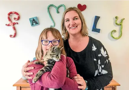  ?? STU HUNT/STUFF ?? Jody Nichols with her daughter Lily, who has Down syndrome, and Simba the kitten. Nichols says a recent storyline in the Kiwi soap opera Shortland Street about Down syndrome was a missed opportunit­y to have a balanced discussion about the condition.