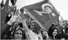  ?? PHOTO: REUTERS ?? Supporters of Turkish President Tayyip Erdogan wave national flags as they wait for his arrival at the Presidenti­al Palace in Ankara