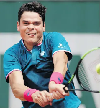  ?? PETR DAVID JOSEK/THE ASSOCIATED PRESS ?? Ontario’s Milos Raonic returns the ball to Steve Darcis during the first round of the French Open on Monday in Paris. Raonic won the match 6-3, 6-4, 6-2.