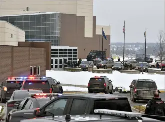  ?? TODD MCINTURF — THE DETROIT NEWS VIA AP ?? Dozens of police, fire, and EMS personnel work on the scene of a shooting at Oxford High School Nov. 30, 2021, In Oxford Township.