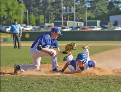  ?? Terrance Armstard/News-Times ?? Play at first: Parkers Chapel first baseman Reece Griffin tries to put the tag on Spring Hill's Kaleb Blair during their game earlier this month at Parkers Chapel. On Tuesday, the Trojans rallied to top the Bears 9-8 at Spring Hill, clinching a berth in the regional tournament in the process. Today, the Trojans will host Taylor. Game time is set for 4:30 p.m. The Trojans will also be hosting the 7-2A East District Tournament, which gets underway next week.