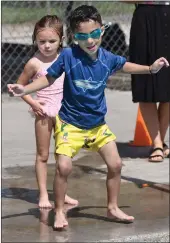  ?? ?? Michael Elias, 5, gets ready to jump at the pool followed by Magnolia Barkley, 4, during a swimming lesson on a hot day at Shamel Park in Riverside on Monday.