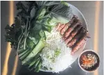  ??  ?? A couple of Anh Dao Restaurant’s Vietnamese specialiti­es include nem nuong (garlicky pork sausages), left, and bo la lot banh hoi (bundles of beef wrapped in betel leaves).