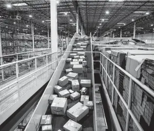  ?? Michael Nagle / Bloomberg ?? Packages move along a conveyor at an Amazon fulfillmen­t center on Cyber Monday. Adobe Digital Economy Index expects Cyber Monday to bring the biggest holiday shopping of the year.