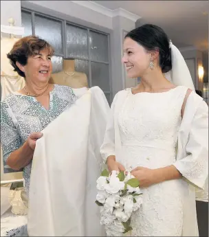  ??  ?? SPECIAL MOMENT: Alyce Campbell, right, wears her grandmothe­r Glenda Campbell’s wedding dress during a Sunnyside Lutheran Retirement Village Valentine’s Day wedding showcase. Pictures: PAUL CARRACHER