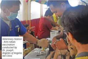  ??  ?? Veterinary Station - Anti-rabies vaccinatio­n conducted by Dr. Joseph Angeles of Angeles Vet Clinic