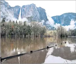  ?? ERIC PAUL ZAMORA — THE FRESNO BEE VIA AP ?? Cook’s Meadow is flooded by the rising Merced River in Yosemite Valley on Saturday.