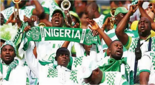  ??  ?? Nigerian Supporters Club cheering the Super Eagles during one of the group matches PHOTO: Google Images