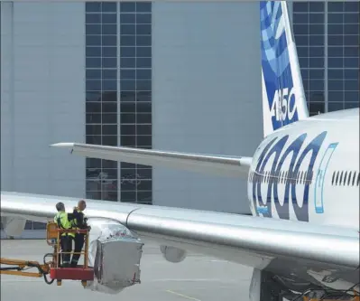  ?? REUTERS ?? Employees of Airbus inspect an A350 plane without engines at the Airbus plant in Hamburg, Germany.