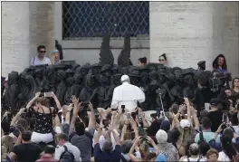  ?? ANDREW MEDICHINI — THE ASSOCIATED PRESS ?? Pope Francis unveils “Angels Unaware,” a sculpture with the theme of refugees and migration, on World Day of Migrants and Refugees in St. Peter’s Square on Sunday.