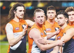  ??  ?? ABOVE: Johnson thanks his teammates after his final game as a Giant last month. TOP RIGHT: With partner Erin and their children Archie 4, and Maggie 2. BOTTOM RIGHT: With Cats teammates Darren Milburn, James Kelly, Tom Harley and Cameron Ling after...