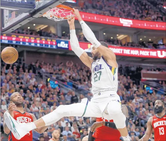  ?? KIM RAFF/AP ?? The Jazz’s Rudy Gobert, dunking against the Rockets on Feb. 22, said his relationsh­ip with teammate Donovan Mitchell will never be perfect after both players endured the coronaviru­s.