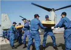  ?? Reuters ?? Japan Self Defence Force’s soldiers load earthquake relief items for Kumamoto region onto a US military aircraft, off Kumamoto prefecture on Tuesday.