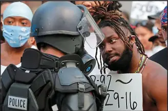  ?? AP ?? Face to face: Protester and police officer in Raleigh, North Carolina