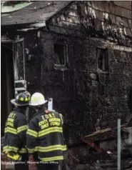  ?? MICHAEL APPLETON — OFFICE OF THE MAYOR VIA AP ?? New York Fire Department personnel stand outside the scene of a deadly fire Sunday in Queens Village in New York that killed multiple people, including children. The fire broke out Sunday afternoon on a street full of single-family homes in the middle...