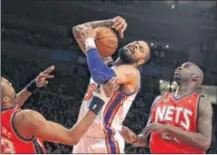  ?? MCT PHOTO BY JIM MCISAAC ?? The New York Knicks’ Tyson Chandler (6) battles for the ball against the New Jersey Nets’ Shelden Williams (33) at Madison Square Gardens in New York City, on Monday.