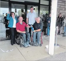  ?? PAULINE ORPWOOD SPECIAL TO THE EXAMINER ?? Otonabee Ward Coun. Lesley Parnell, wheelchair curler Carl Bax, Peterborou­gh Curling Club president Bruce Thompson and wheelchair curler Alec Denys take part in a ribbon-cutting ceremony Tuesday at the Peterborou­gh Curling Club at 2195 Lansdowne St. W. after the completion of an upgrade of the front and side doors of the curling club with new motorized accessibil­ity features and energy saving benefits.