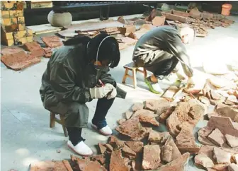  ??  ?? 合江漢棺修復現場，曹元元和她的老師。 （取材自華西都市報）