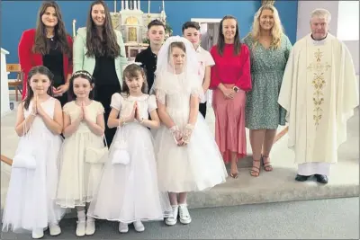  ?? ?? Following the First Holy Communion and Confirmati­on ceremonies in Glenroe, Muinteoirí Kate, Marie, Julie and Charlotte, along with Fr Michael O’Shea, are pictured with pupils Mollie, Aoife, Rebecca, Aurora, Daniel and Danny.