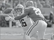  ?? John Raoux / The Associated Press ?? LSU quarterbac­k Danny Etling (16) throws a pass as he is hit by Florida linebacker Kylan Johnson on Saturday.