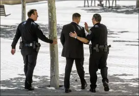  ?? JAY JANNER / AMERICAN-STATESMAN ?? Austin Assistant Police Chief Joseph Chacon (right) congratula­tes FBI Assistant Special Agent in Charge John Scata as they walk away from federal court in Austin on Thursday after Chimene Onyeri was found guilty. With them is Austin Assistant Police...