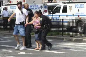  ?? MARY ALTAFFER — ASSOCIATED PRESS ?? Police help people cross the street outside the Bronx Lebanon Hospital in New York after a gunman opened fire there on Friday, June 30, 2017. The gunman, identified as Dr. Henry Bello who used to work at the hospital, returned with a rifle hidden under...