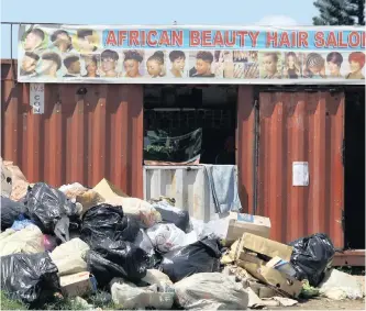  ??  ?? RUBBISH which has not been collected by the municipali­ty in the las three weeks is affecting the community and street vendors in umlazi. |