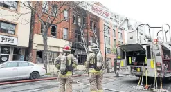  ?? RICHARD LAUTENS TORONTO STARGETTY IMAGES ?? Fire crews work at the scene of a fire at the historic Peacock Hotel in the Junction Thursday morning.