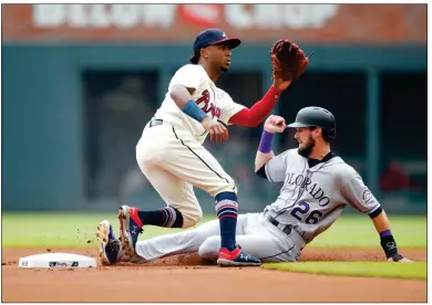  ?? / AP-Todd Kirkland ?? Above: Rockies David Dahl steals second base as Braves second baseman Ozzie Albies receives the throw in the game in Atlanta on Sunday. Below: Rockies’ DJ LeMahieu hits a solo home run in the third inning of the game.
