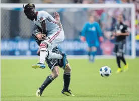  ?? CANADIAN PRESS FILE PHOTO ?? Toronto FC’s Tosaint Ricketts, front, and the Vancouver Whitecaps’ Marcel de Jong collide during the first leg of the Canadian championsh­ip on Aug. 8. Level at 2-2, the teams will play the deciding match at BMO Field in Toronto on Wednesday.