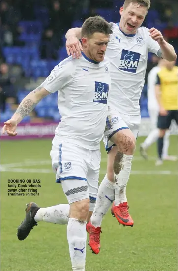  ??  ?? COOKING ON GAS: Andy Cook wheels away after firing Tranmere in front