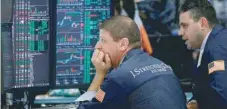  ?? — Reuters ?? Traders work on the floor of the New York Stock Exchange.